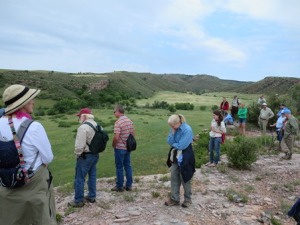 Hikers look over the edge of the buffalo jump to the valley below. The Sanson family owned this property from 1882 to 1987. It then was purchased by the Casey family. The Conservation Fund, a nonprofit dedicated to protecting important places across America, acquired the property at auction from the Casey family when it became available, and held it until federal funds became available to purchase it. The land is now part of Wind Cave National Park.
