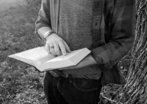 Cowboy Poetry reading a poem -- free-use-photo-unsplash-by-Cassidy-Kelley
